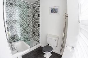 a bathroom with a shower and a toilet and a sink at Broome Park Hotel in Canterbury