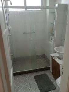 a bathroom with a shower with a glass door at Apto Olaria in Rio de Janeiro