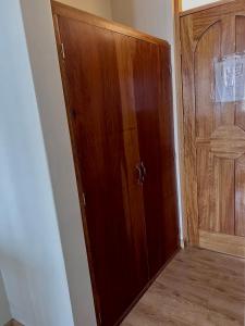 a wooden door in a room with a wooden floor at América inn in Puno