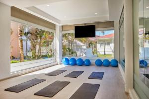 a room with a large window with yoga mats at Bahia Principe Luxury Ambar - Adults Only All Inclusive in Punta Cana