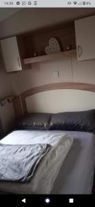a bed in a room with at Deluxe 3 bedroom Lyons Robin hood oaklands with free wifi free sky in Meliden +30 photos