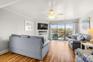 a living room with two couches and a ceiling fan at QB1- Michele's Seashell in Nags Head