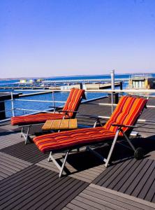 two chairs sitting on the deck of a boat at Hausboot Schatzinsel in Klitten