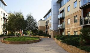 a small park in a courtyard between two buildings at The Grove - Properties Unique in Newcastle upon Tyne