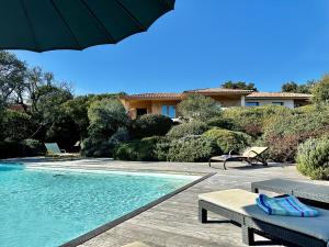 una casa con piscina y sombrilla en Villa Pina, en Sainte-Lucie de Porto-Vecchio