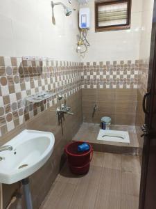 a bathroom with a sink and a toilet at V1 Stay Home in Tirupati