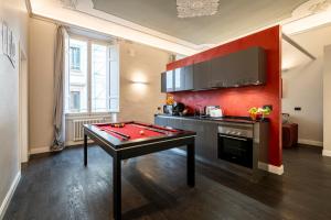 a room with a ping pong table in a room at Cherubini Palace Thematic Apartment in Florence