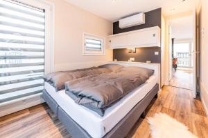 a large bed in a room with a large window at Hausboot Atlantis in Klitten