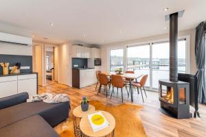 a living room with a couch and a fireplace at Hausboot Atlantis in Klitten