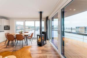 a kitchen and dining room with a wood stove at Hausboot Atlantis in Klitten