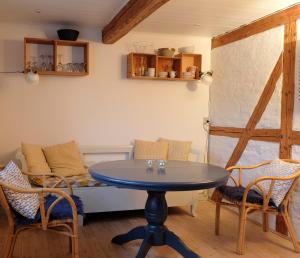 a dining room with a table and chairs at Millinge Gamle Skole in Millinge