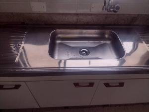 a stainless steel sink in an empty kitchen at Cobertura duplex piscina churras e 2 vagas super arejado in Mongaguá +34 photos