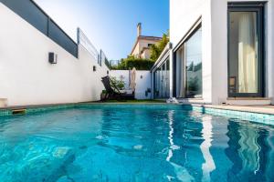 a swimming pool in front of a house at Luxury Villa with a pool in the city - No Parties Allowed in Lisbon