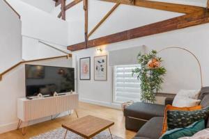 a living room with a couch and a tv at Host & Stay - The Cavern Quarter Loft in Liverpool