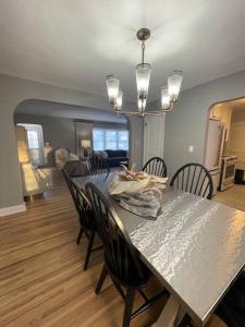 a dining table and chairs in a living room at The Warm & Inviting Place in Sioux Falls