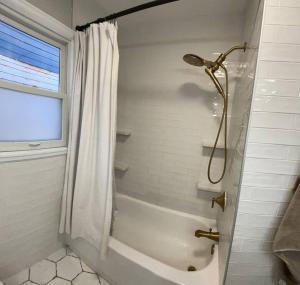 a bathroom with a shower with a shower curtain at The Warm & Inviting Place in Sioux Falls +29 photos