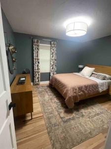 a bedroom with a bed and a table and a window at The Warm & Inviting Place in Sioux Falls