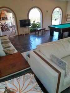 a living room with couches and a pool table at Mansão Mar casado in Guarujá