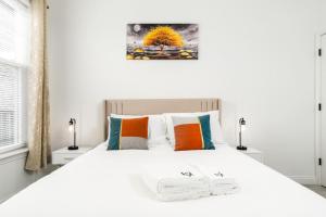 um quarto com uma cama branca com duas toalhas em Corporate Housing by MGM em Whitestown