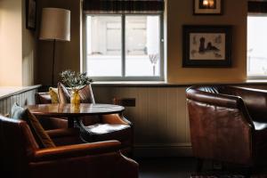 a room with a table and chairs and a window at Victoria in Holkham