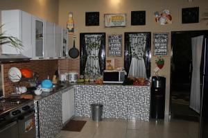 a kitchen with a tile counter top in a room at Villa Aurora Lovina in Lovina