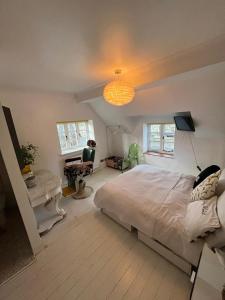 a bedroom with a bed and a desk and a lamp at Town and country in Stamford