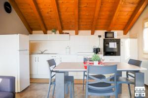 a kitchen with a dining room table and chairs at COLOMBERA by Design Studio in Bellano