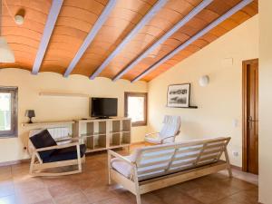 a living room with a couch and a tv at Aiguabella - Allotjaments Rurals in Sant Feliu de Pallerols