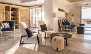 a living room with chairs and a table at Summer Senses Luxury Resort in Logaras