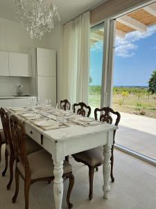 a dining room with a table with wine glasses on it at NOTO country farm house in Noto