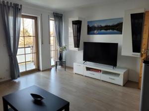 a living room with a flat screen tv at Rudis Ferienwohnung in Kirchham