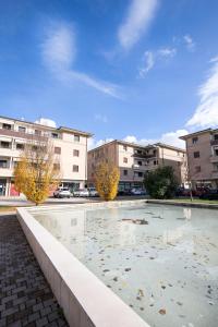 a large pool of water with buildings in the background at Appartamento SERGIO LUXURY CENTRO parking free in Santa Maria degli Angeli