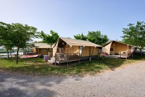 a row of camping cottages on the side of a road at Glamping Costa Brava in Fortiá