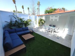 a living room with a couch and a table on a patio at Bungalow BAHIA VERDE in Playa del Ingles