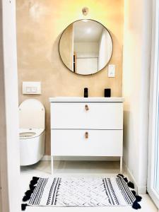 a bathroom with a white dresser and a mirror at La Baraque Calais Blériot 2 in Sangatte