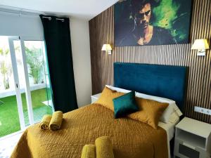 a bedroom with a king sized bed with a blue headboard at Bungalow BAHIA VERDE in Playa del Ingles +17 photos