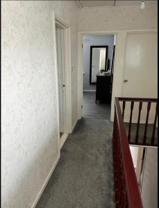 a hallway with a staircase and a room with a stair case at Macs Belfast Single bedroom in Belfast