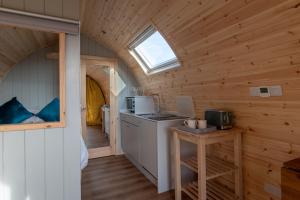 a kitchen in a tiny house with a window at Callander Hostel in Callander