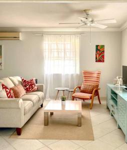 a living room with a couch and a coffee table at Freight’s Reach #6 Cotton Bay in Christ Church