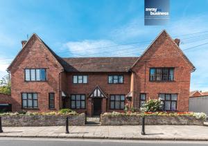 a large red brick house on a street at St Martins Square Chichester in Chichester