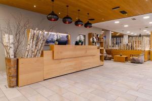 una tienda con un gran mostrador de madera en una habitación en PLAZA INN Dachau - München, en Dachau