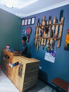 a man sitting at a counter in a store at Safari Park House in Arusha