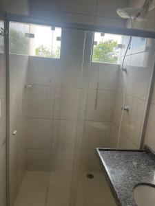 a bathroom with a glass shower with a sink at Condomínio Villa Verde Triunfo in Triunfo +19 photos