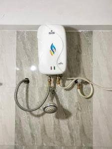 a hair dryer on the wall of a bathroom at 2BHK Oasis in Prime Kharadi in Pune