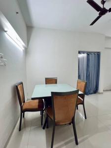 a dining room with a table and chairs at 2BHK Oasis in Prime Kharadi in Pune