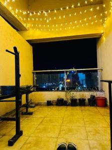 a room with a stage with lights and a table at 2BHK Oasis in Prime Kharadi in Pune