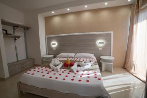 a bedroom with a large bed with red hearts on it at B&B Jerocades in Parghelia