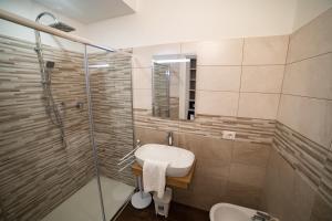 a bathroom with a sink and a shower and a toilet at B&B Jerocades in Parghelia