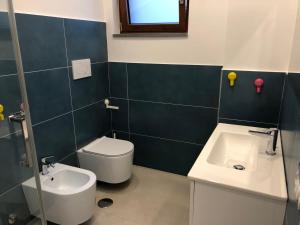 a bathroom with a toilet and a sink at La Casa dei colori in Vico Equense