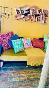 un sofá con almohadas coloridas en una habitación en Boho Glamping en Wilderness